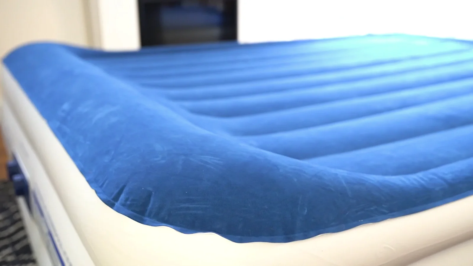 The flocked sleeping surface: sheets grip it instead of skating.