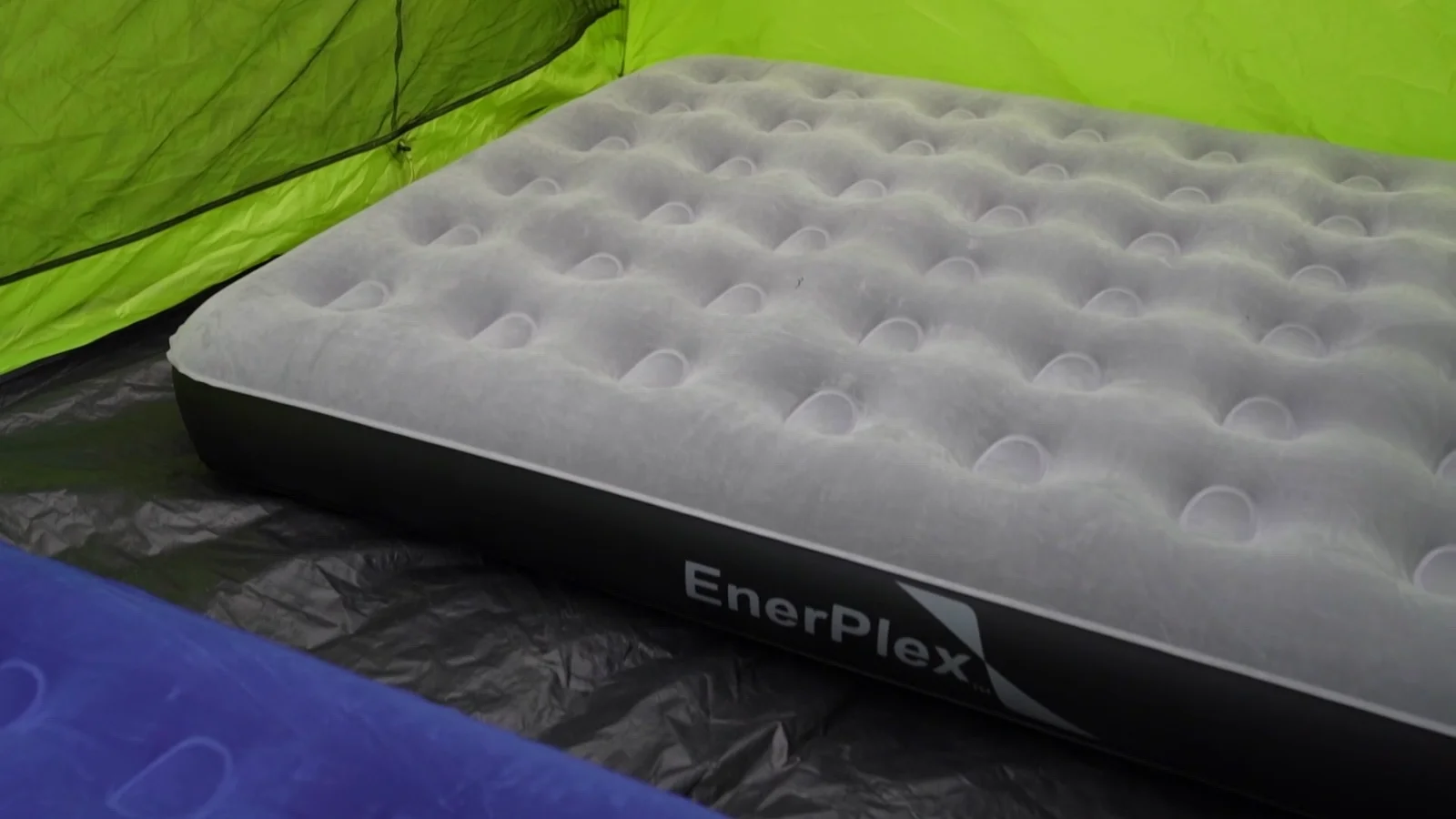 A gray EnerPlex camping airbed inflated in front of a tent